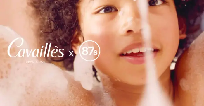 Jeune femme souriante prenant une douche sensorielle avec mousse onctueuse