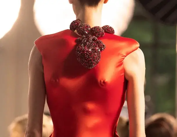 Jeanne Cadieu porte une robe rouge inversée et un collier-cœur battant signé Schiaparelli lors de la Fashion Week 2025